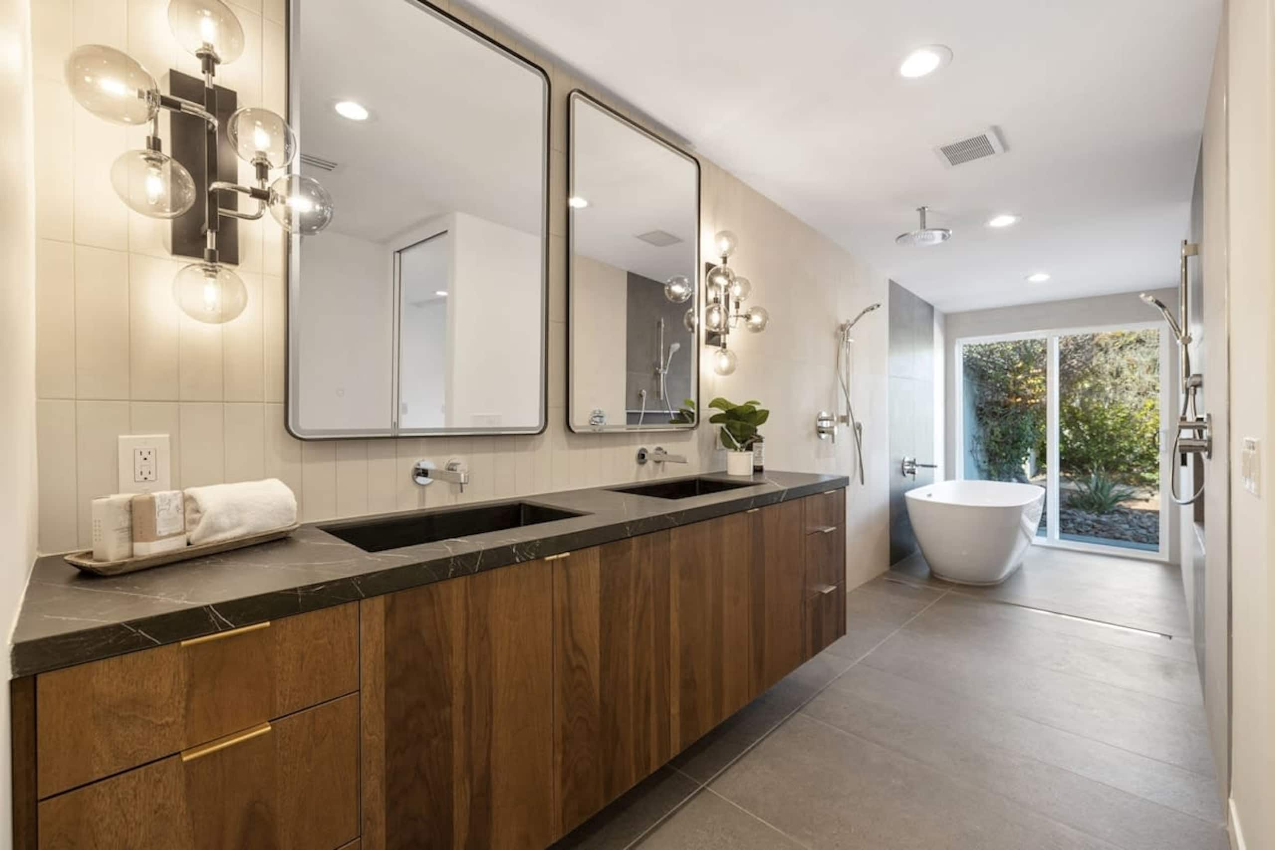 Freestanding tub between double showers