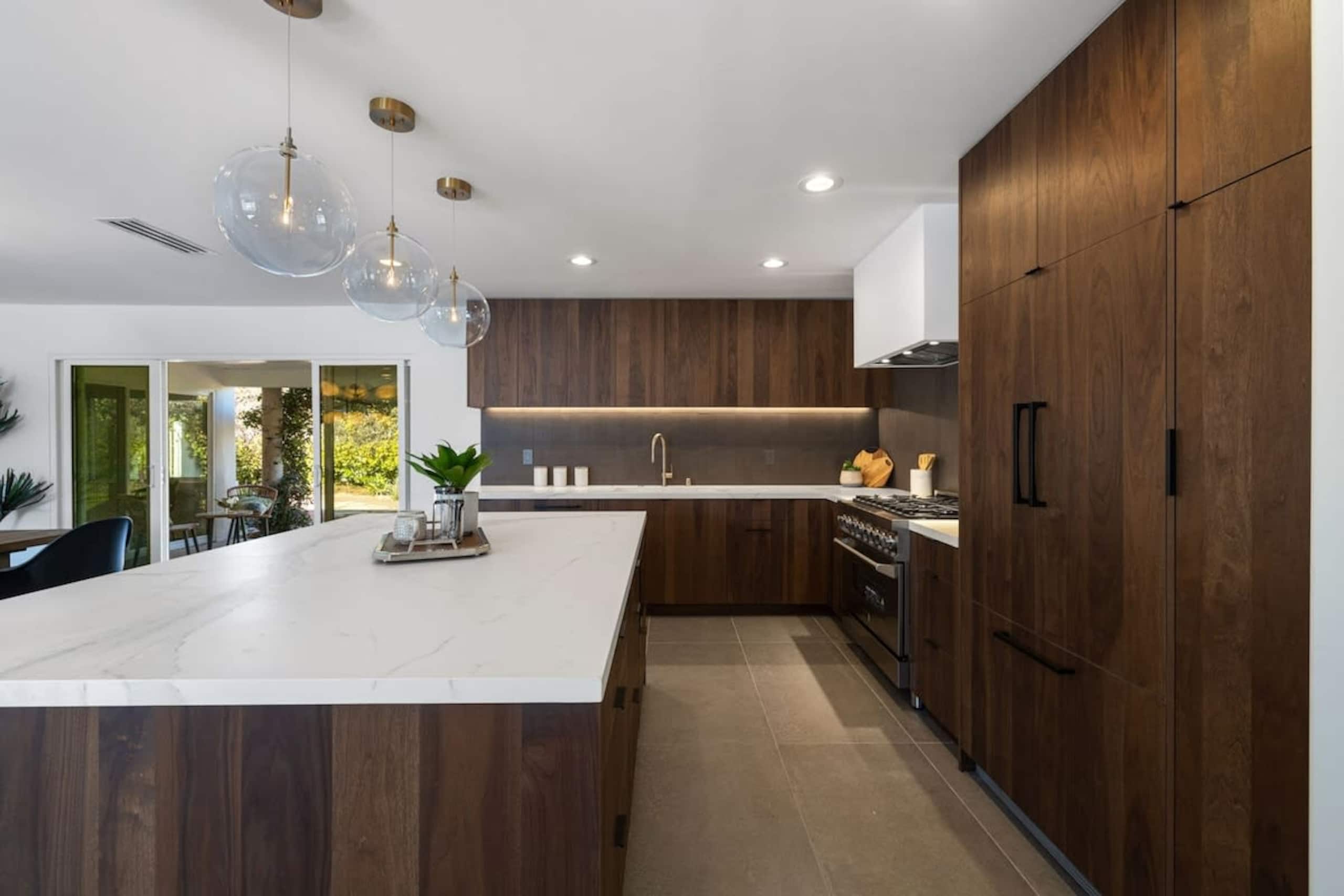 Walnut kitchen with glass pendants