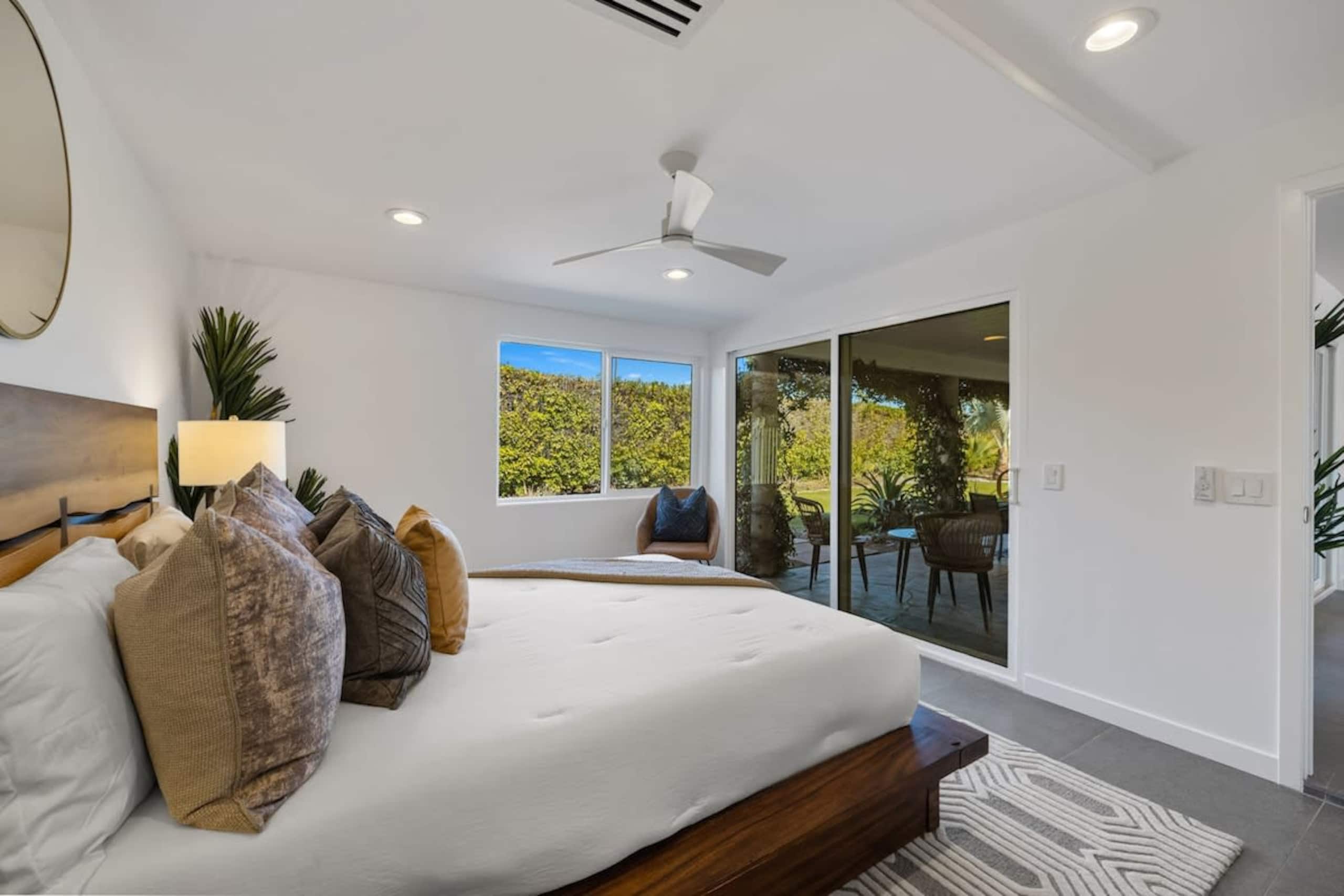 Primary suite with king bed and sliding doors to the patio